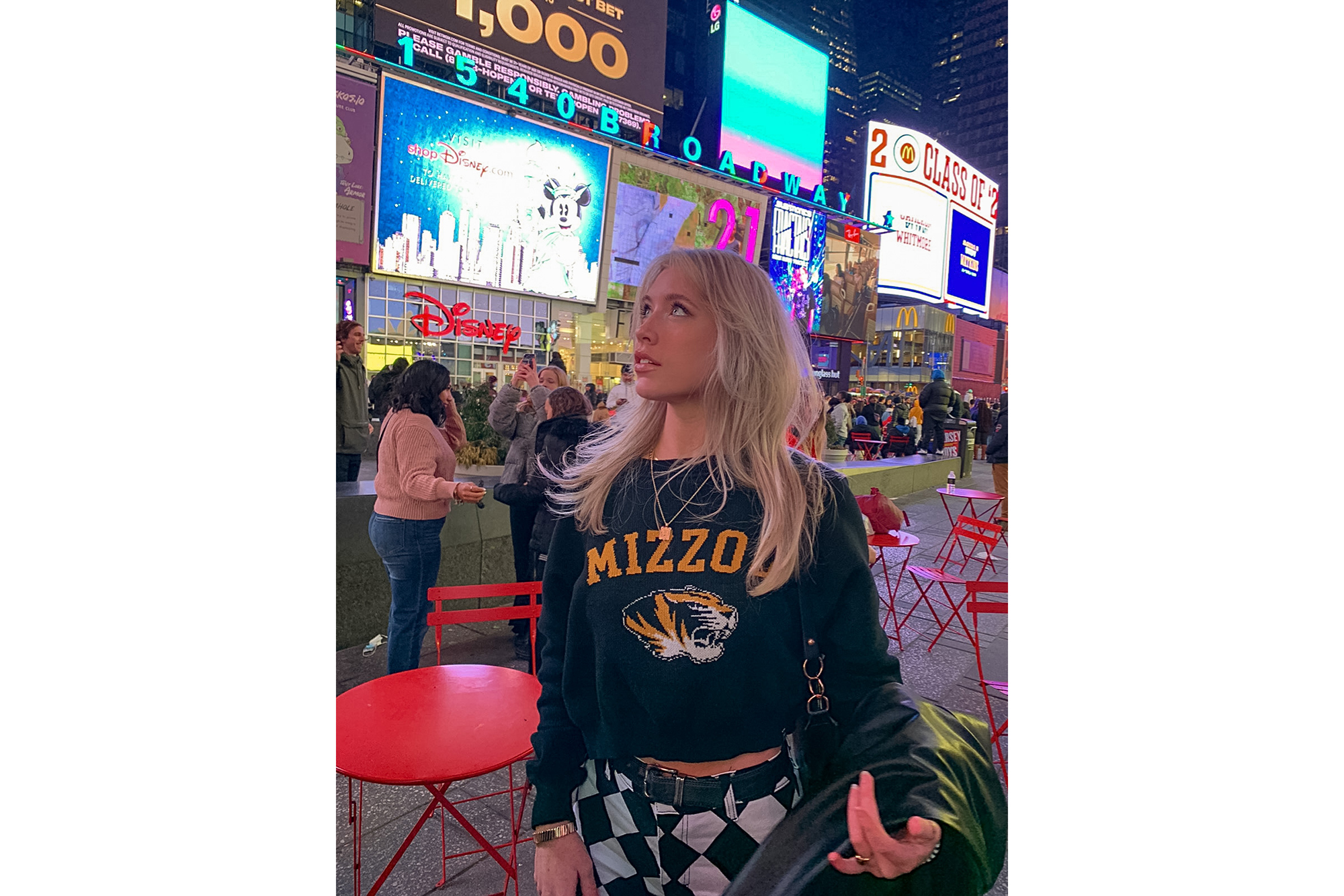 Lexie Schrock in Times Square with a Mizzou sweatshirt on