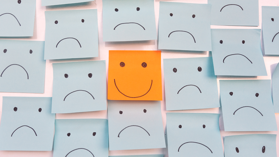 picture of post-it notes with one smiley face and the rest are frowns