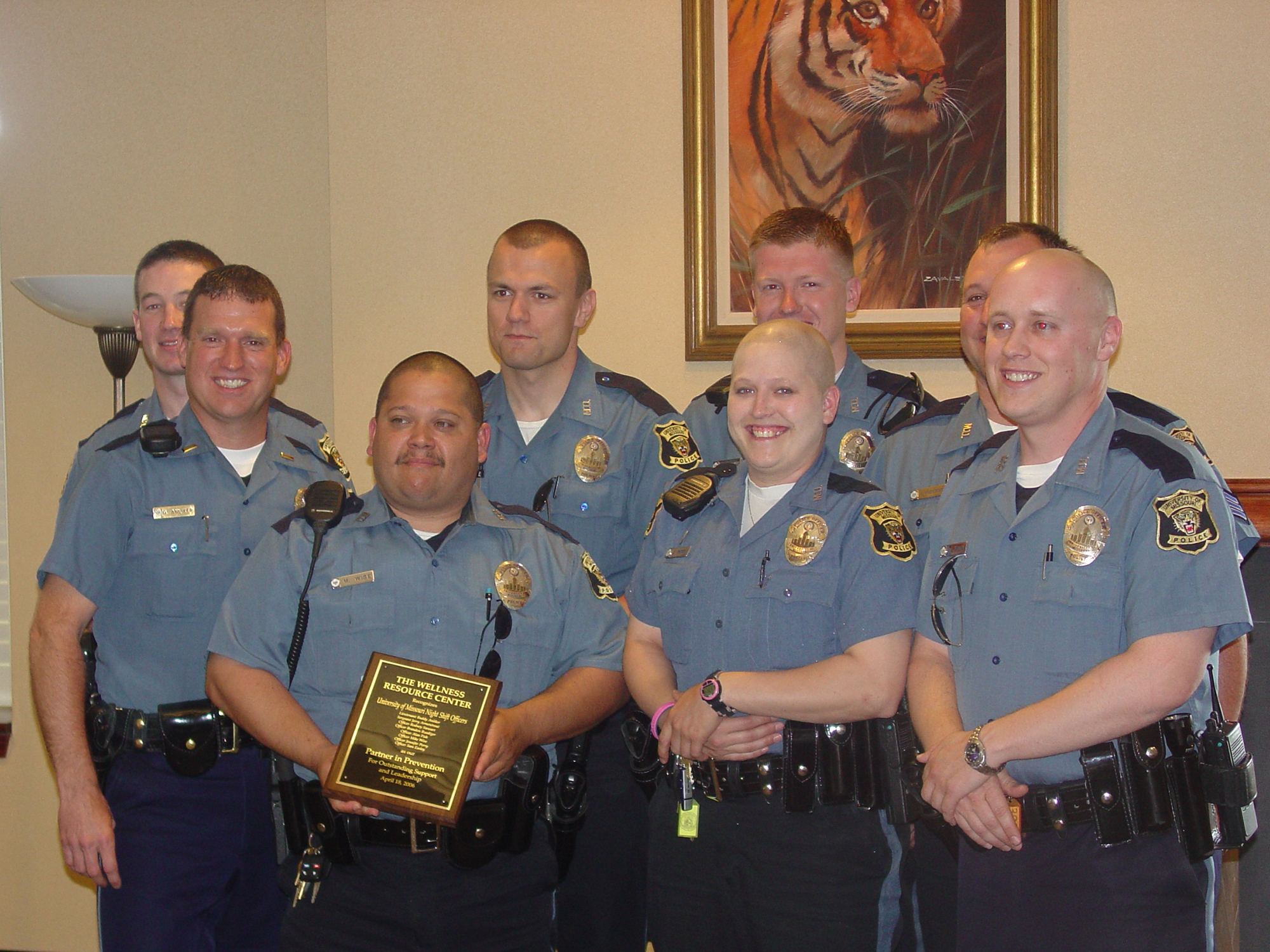 jennifer perry and fellow MUPD officers pose for a photo. perry is bald due to chemotherapy