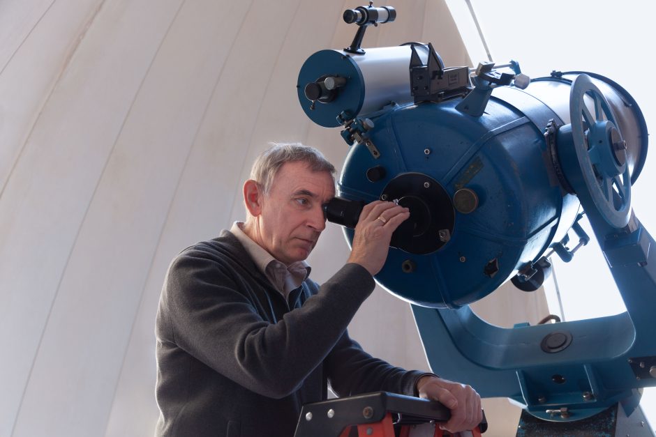 This is an image of Sergei Kopeikin looking into a telescope