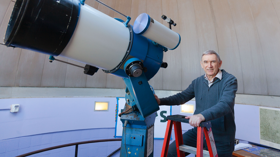 This is an image of Sergei Kopeikin standing next to a telescope