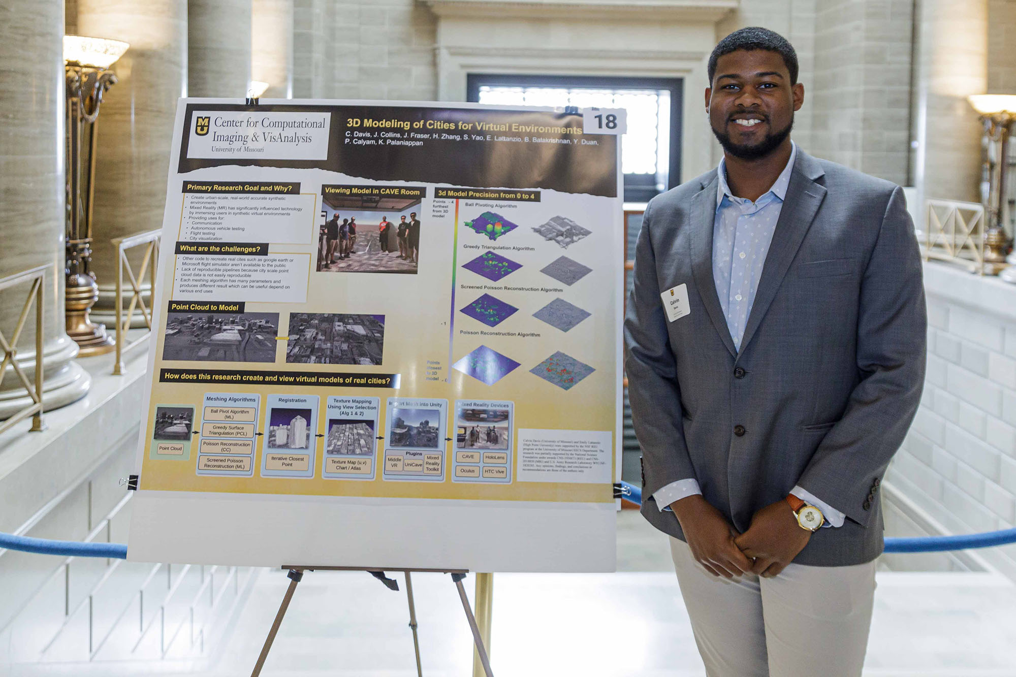 Calvin Davis poses next to his research poster