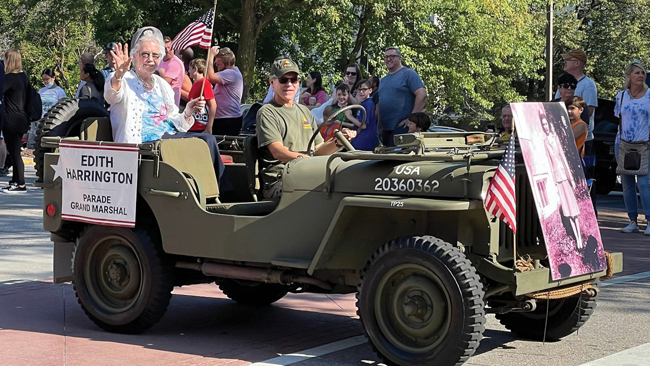 Edith Harrington riding jeep in parade