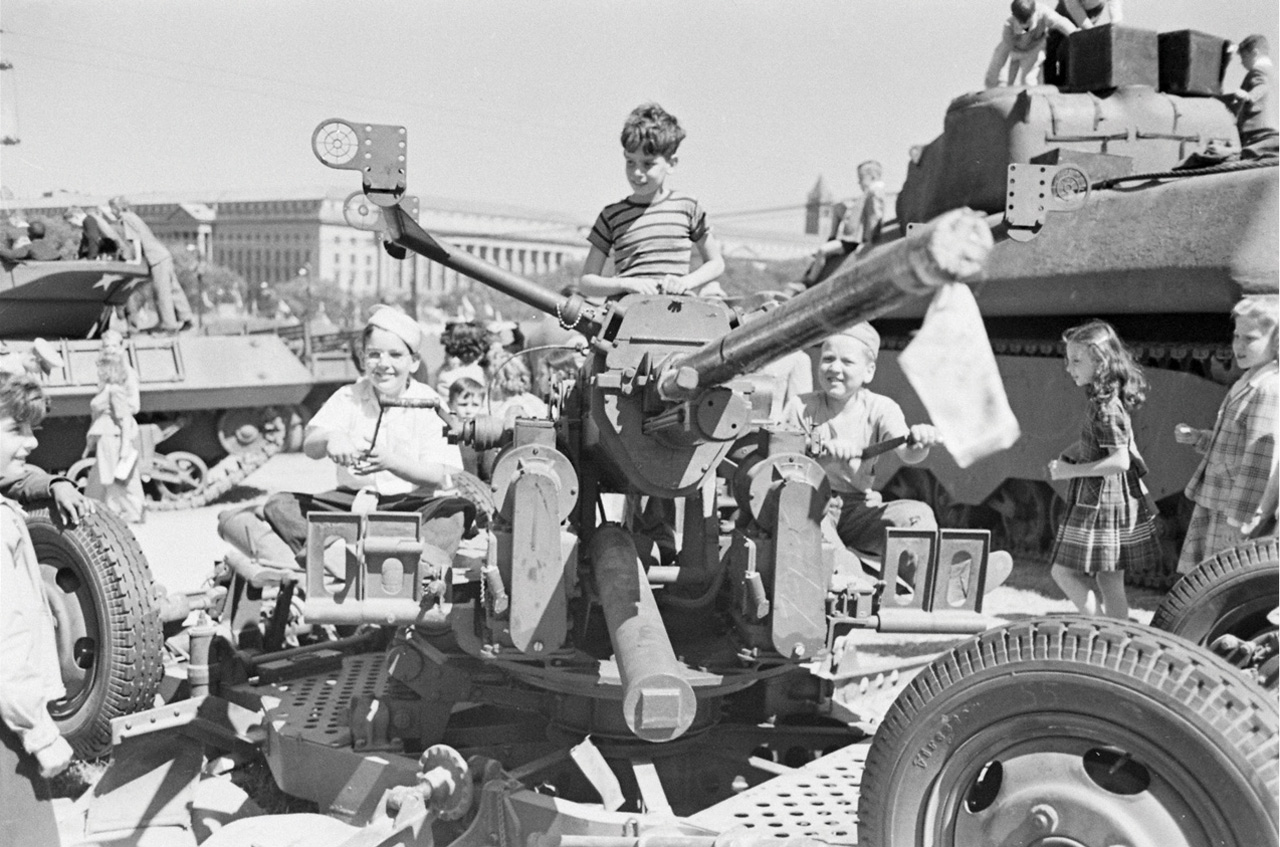 children climbing World War II tank