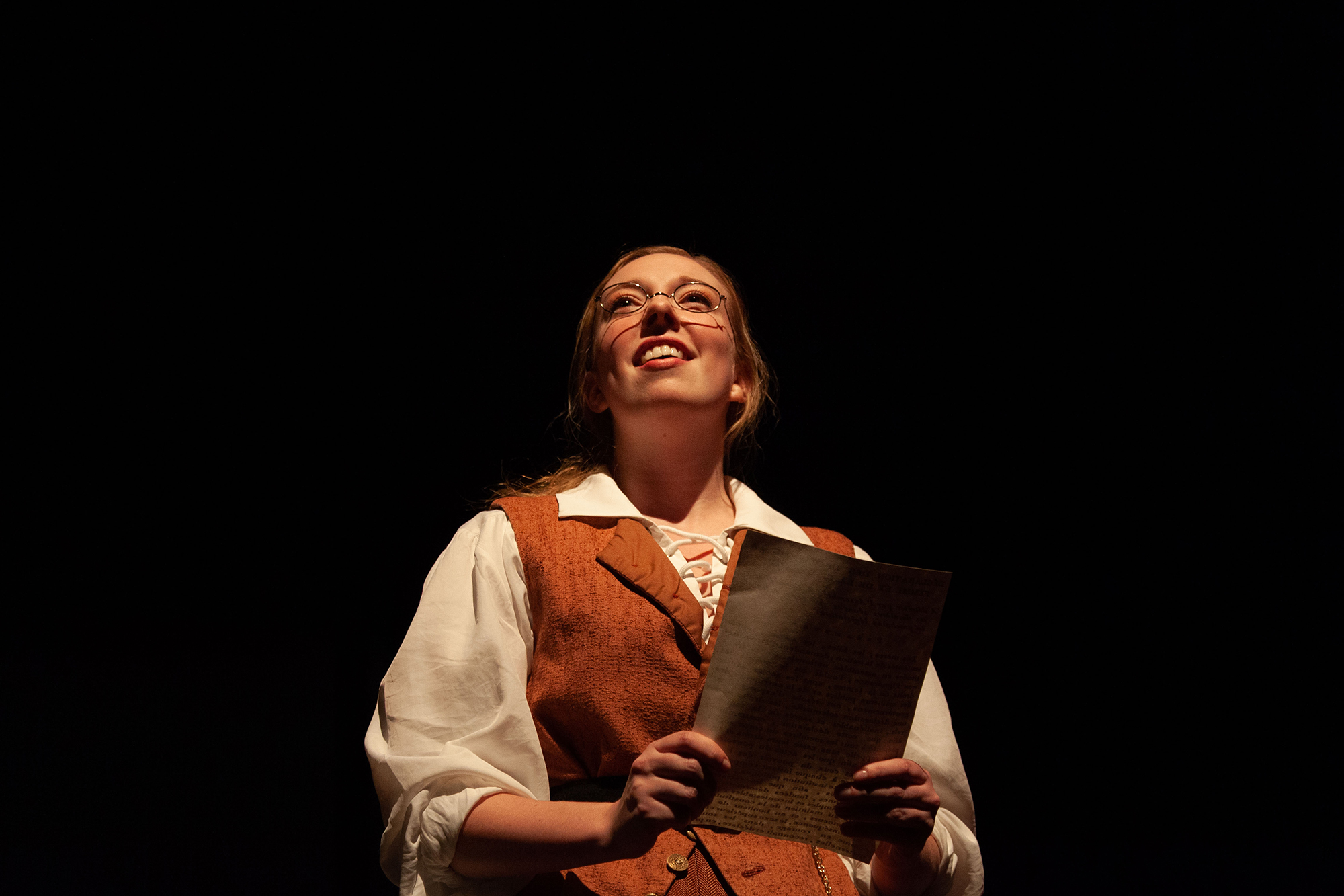 This is a photo of an actor performing in a play, holding a letter