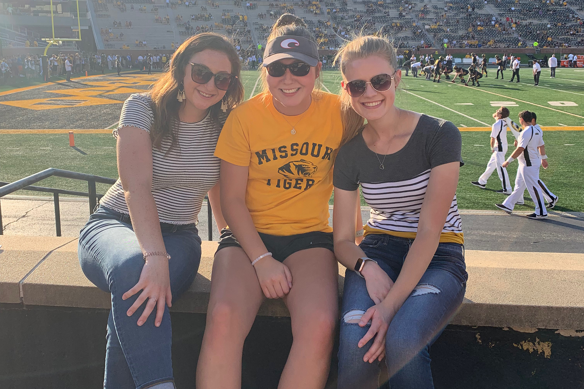Elizabeth Fahrmeier and two friends at a football game