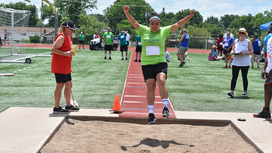 a young athlete competes in the long jump during the special olympics