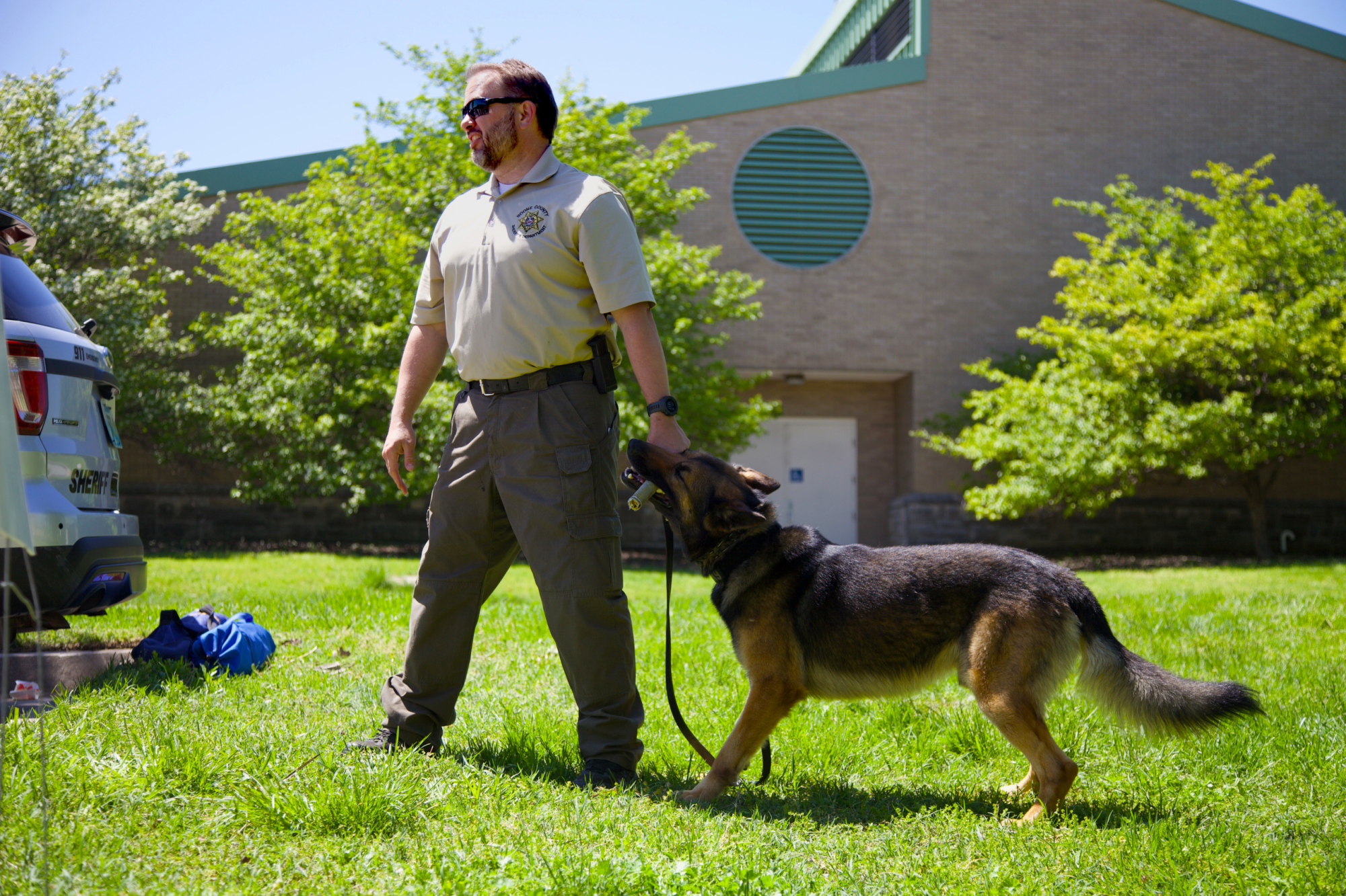 This is an image of someone from the sheriff's department training a dog.