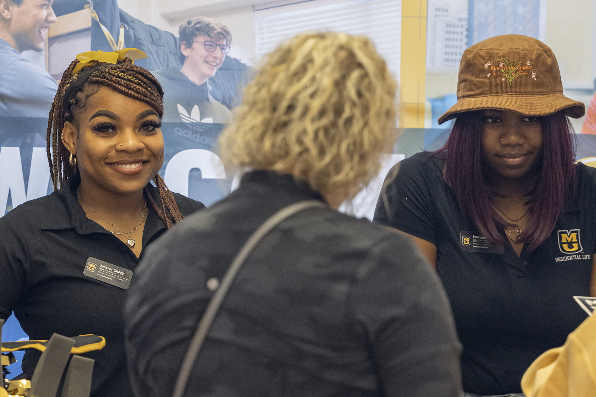 a woman smiles for the camera at an informational fair