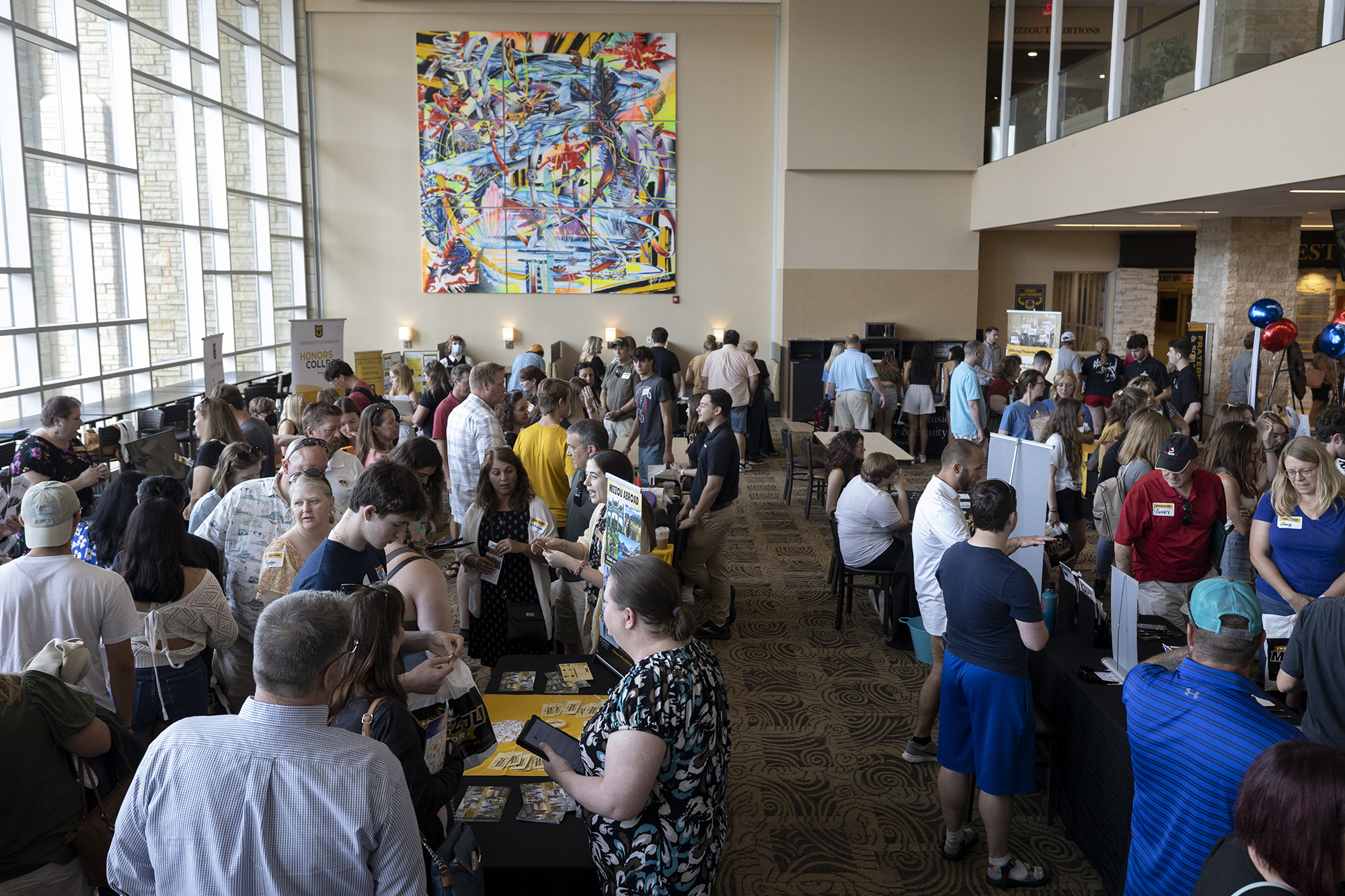 people gather in the mu student center for an information fair