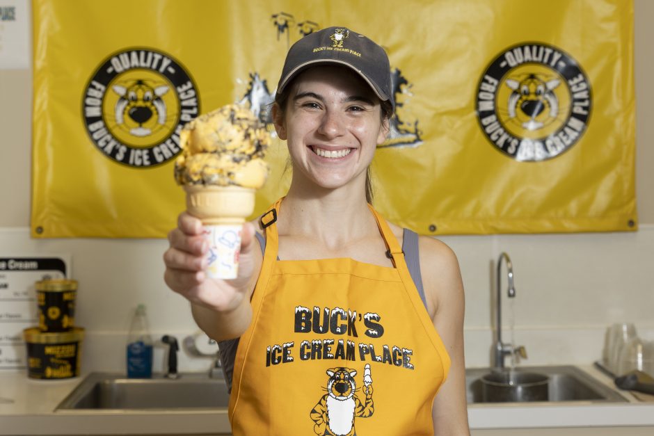 Student presents freshly scooped cone of Tiger Stripe ice cream