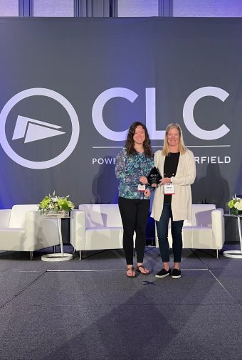 Jessi Church and Sonja Derboven pose on stage with CLC award