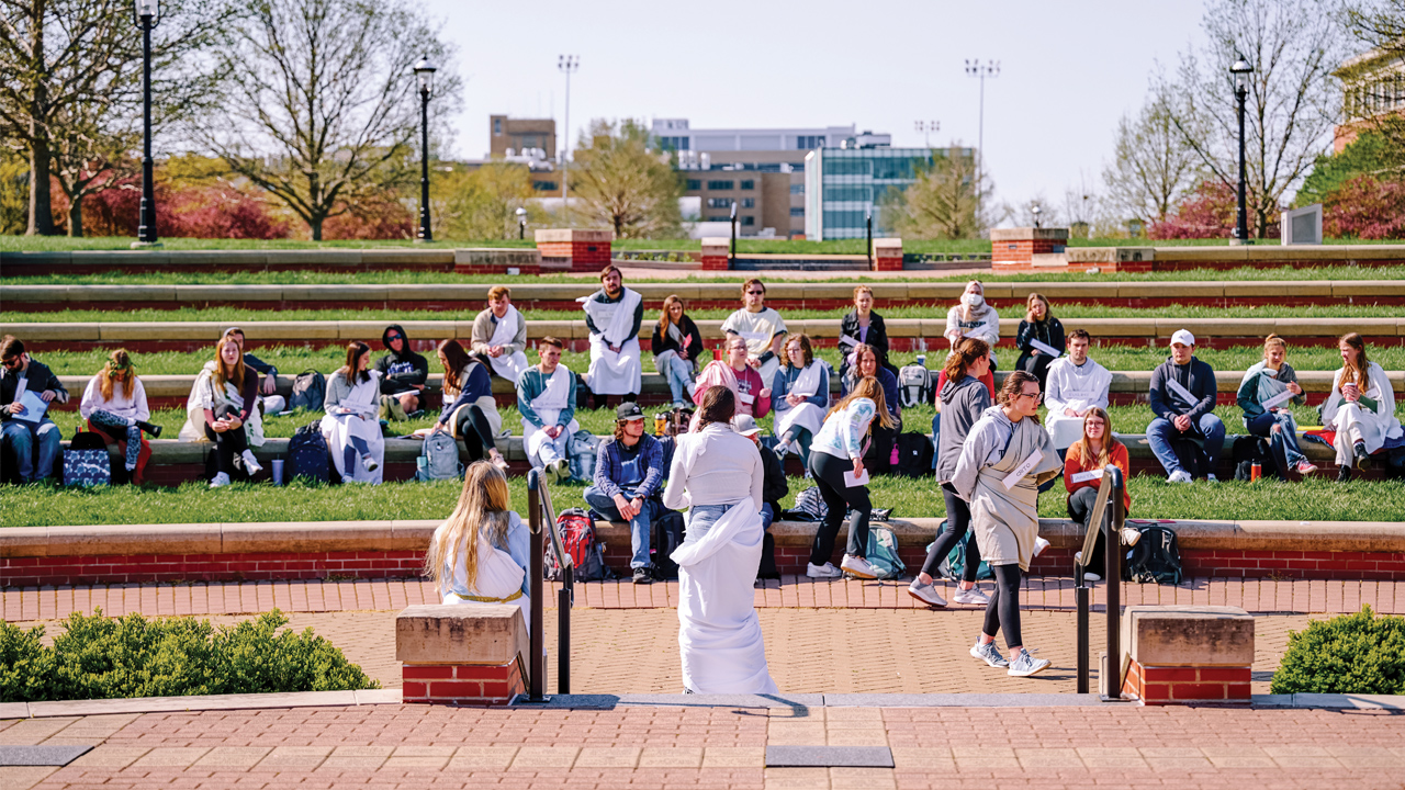 students reenacting trial of Socrates outdoors on campus