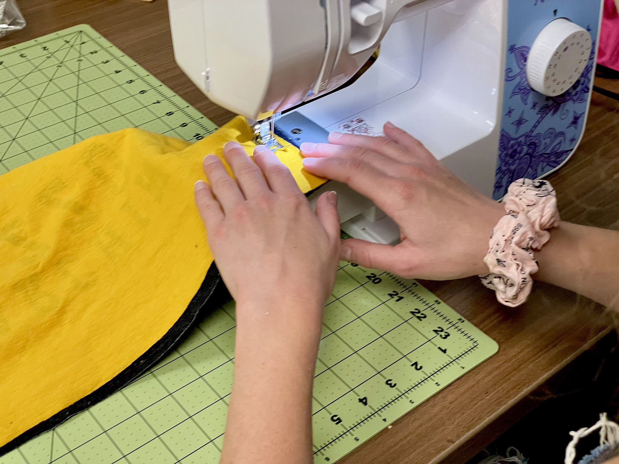 a woman sews a gold shirt