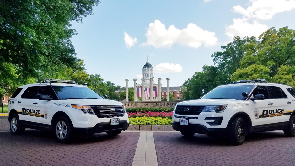 two MUPD cars in front of the columns