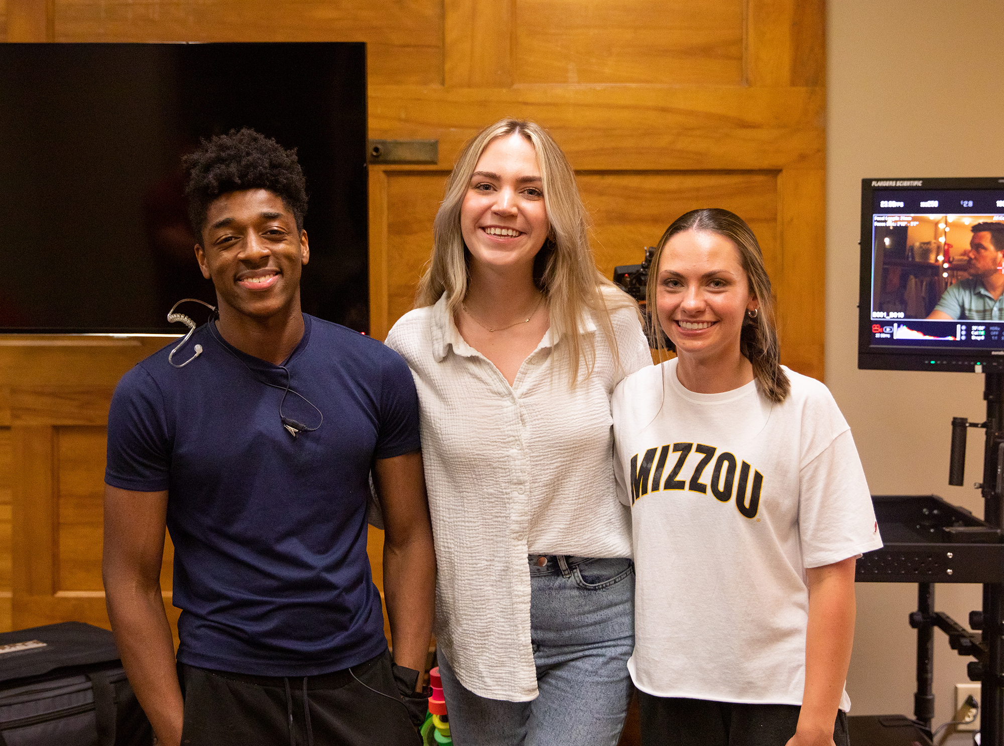 Ty Small, Olivia Jansen and Hunter Mesko pose on set. Mesko is the commercials’ main character, and Small and Jansen make brief cameos. Can you spot them?