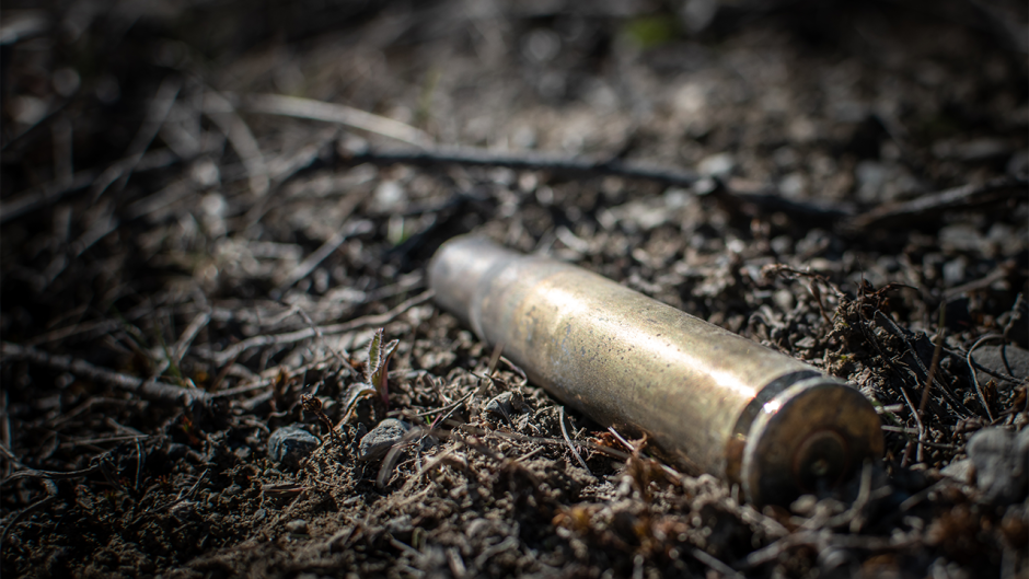 This is an image of a bullet in the ground.