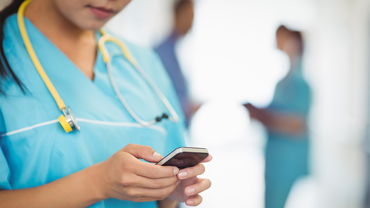 This is a photo of a nurse texting.