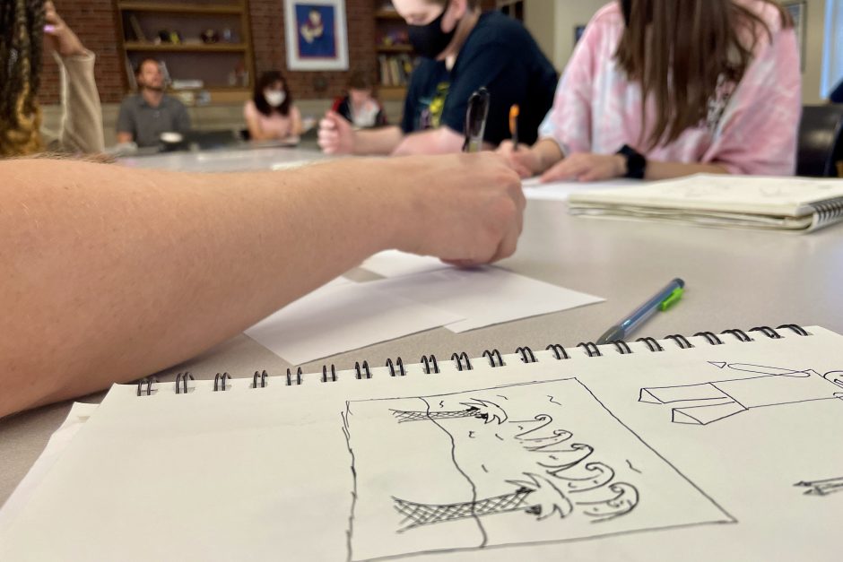 Closeup of students drawing comics