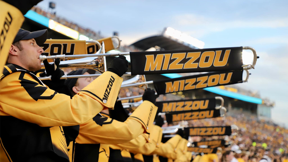 Picture of trombone players playing during a football game