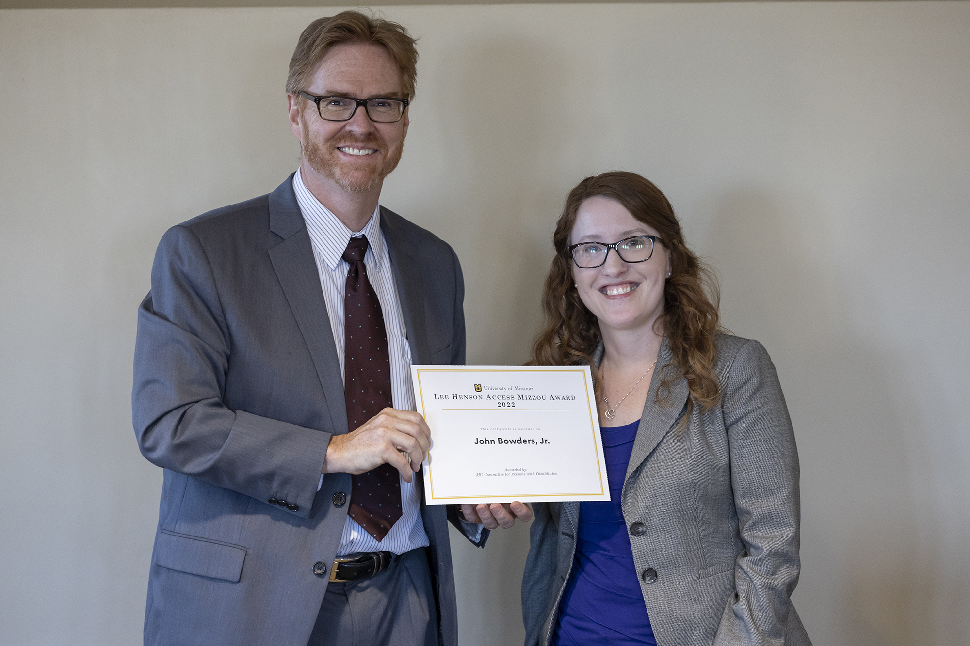 dean manring and amber cheek pose with a certificate