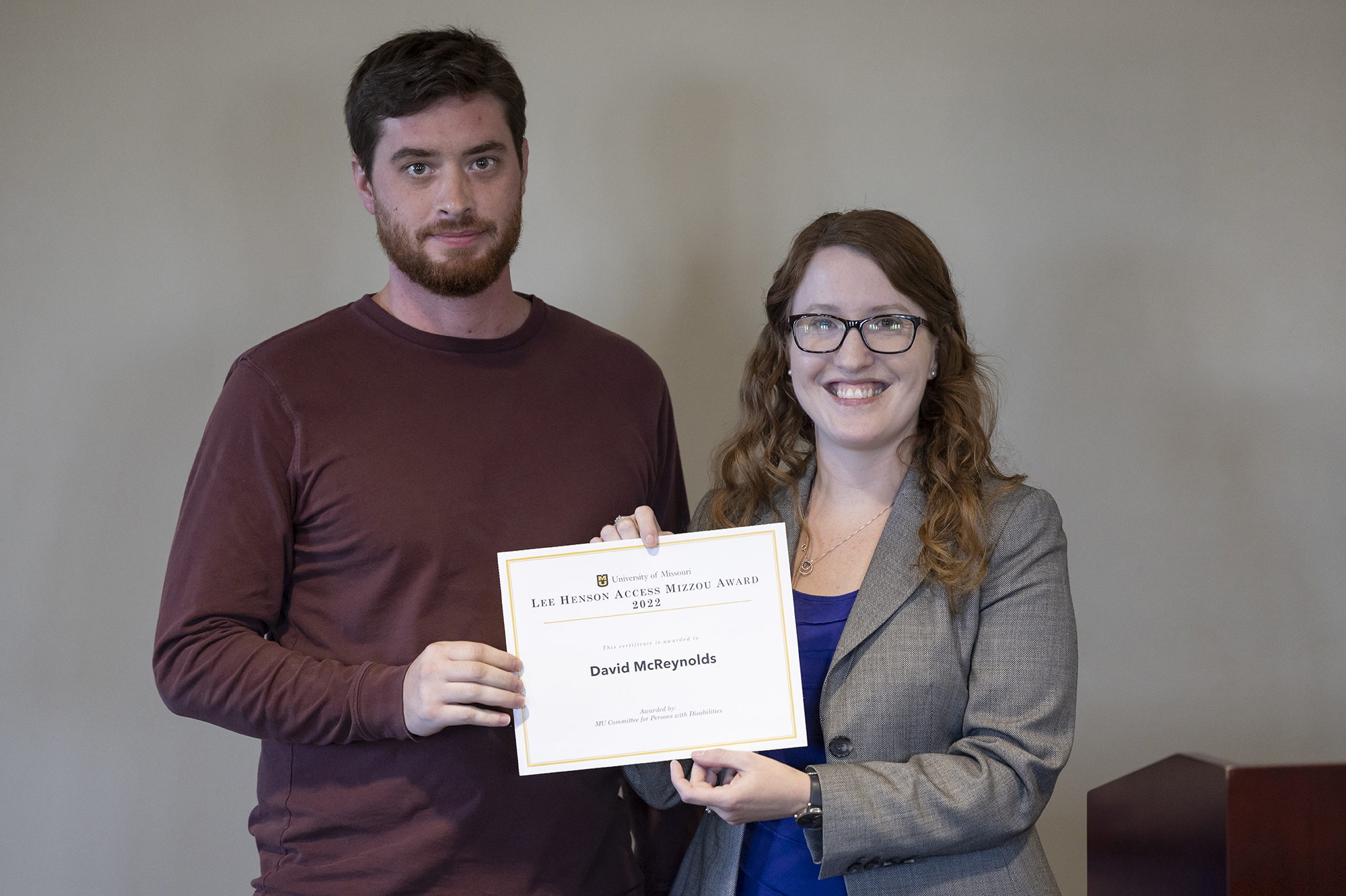 david mcreynolds and amber cheek pose with a certificate