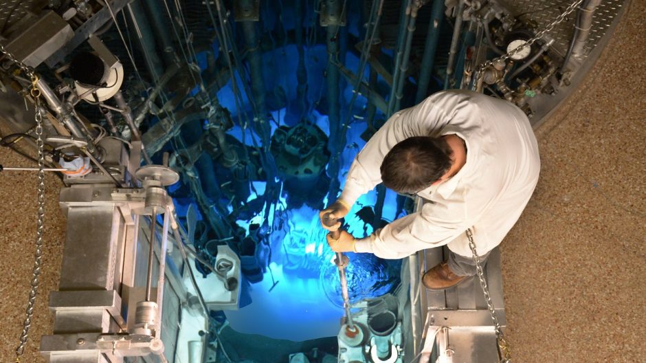 Reactor operator retrieves a sample can from the reactor pool