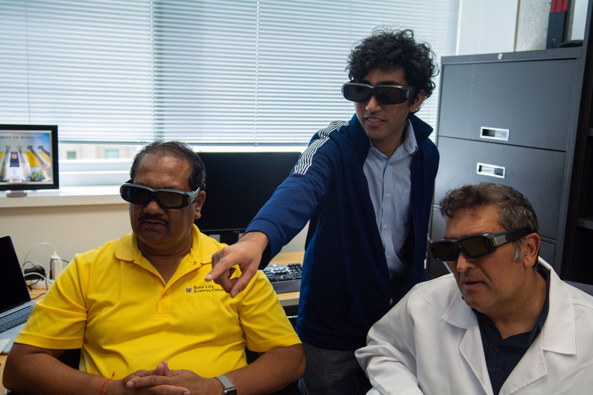 From left: Kamlendra Singh, Saathvik Kannan, and Shrikesh Sachdev analyze a 3D replica of the monkeypox virus.