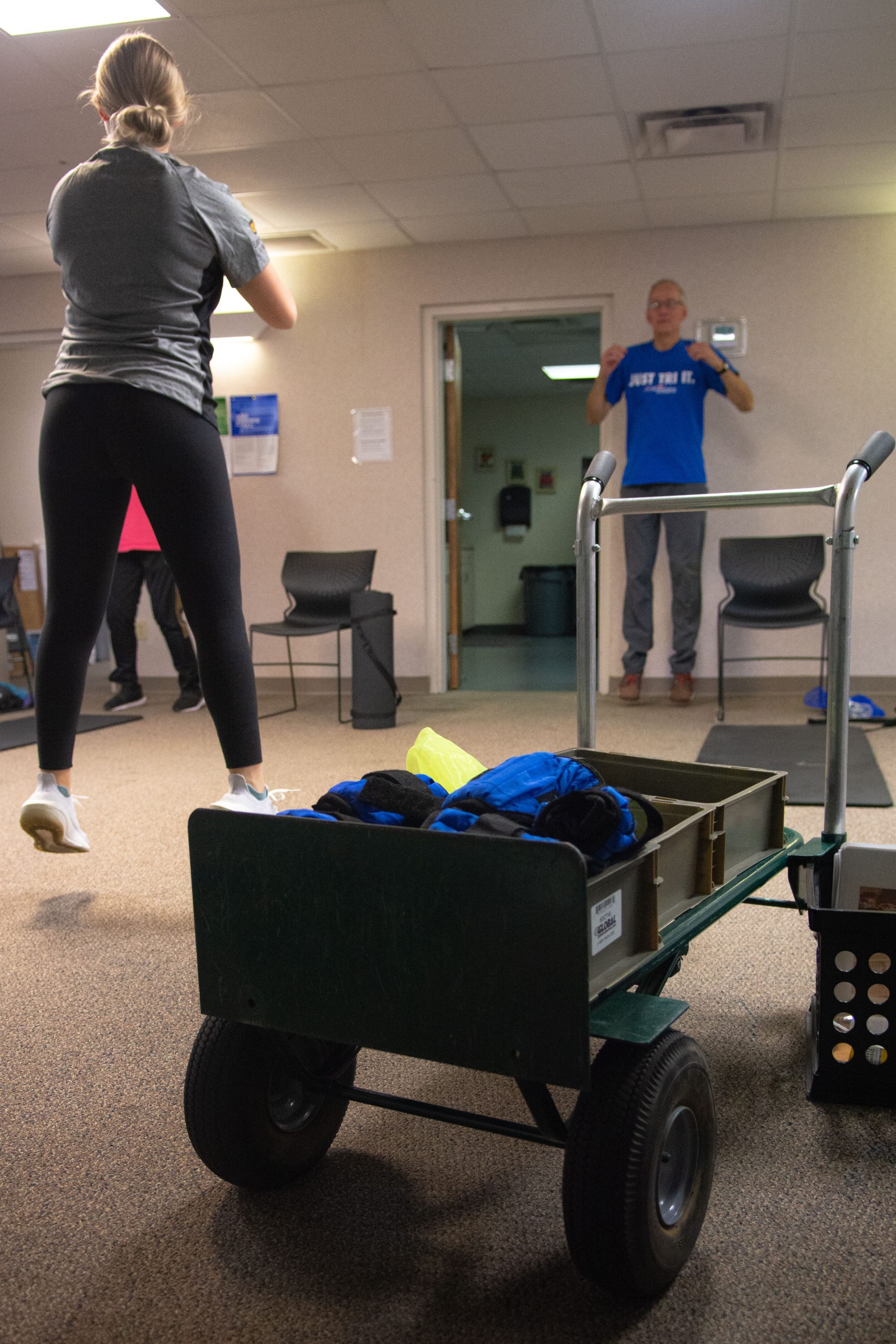 Olivia Damery, an instructor for the Stay Strong, Stay Healthy class leads an exercise in front of a basket of ankle weights.