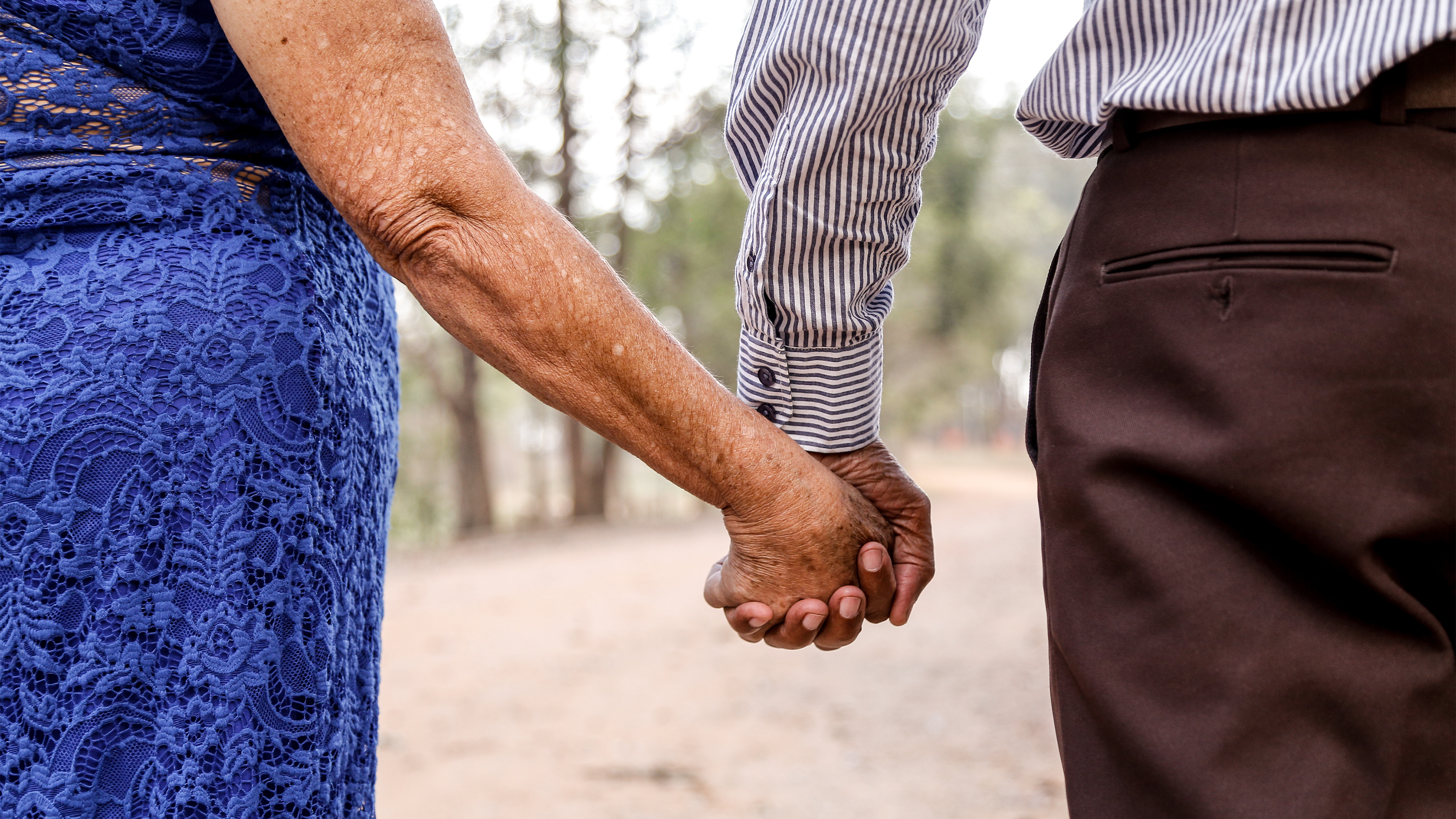 Older adults holding hands.