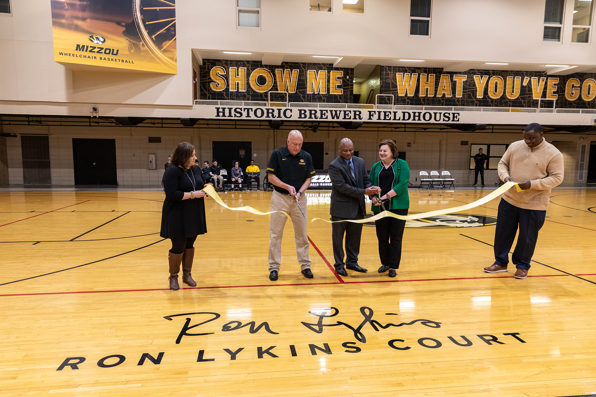 coach lykins and others cut a ribbon at the event