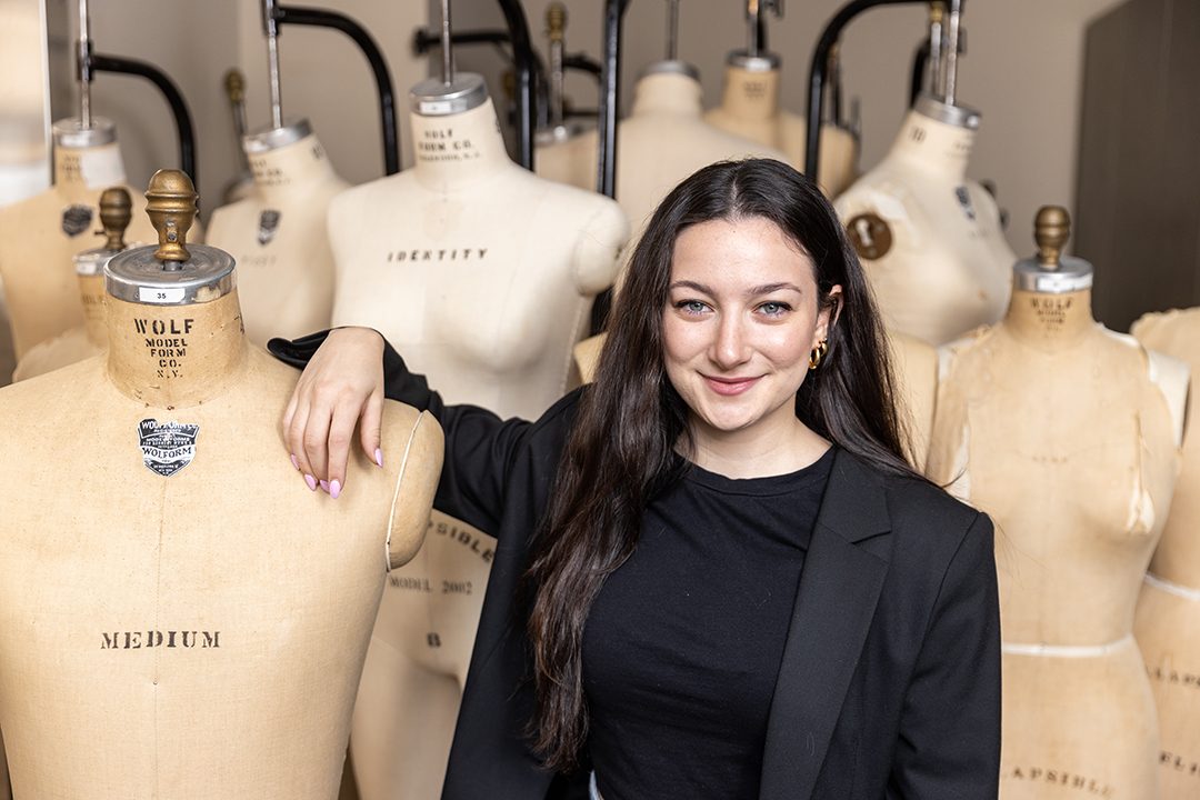 Michelle Gershkovich poses in front of mannequins in one of MU's Textile and Apparel Management labs.