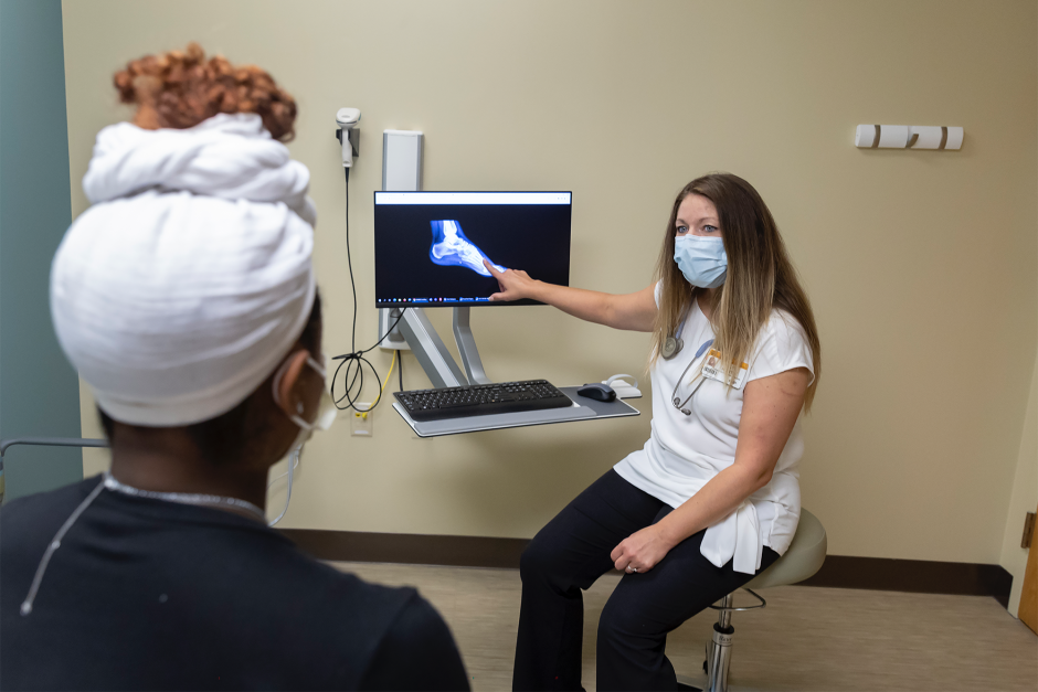 A provider discusses an x-ray with a patient at the MU Student Health Center