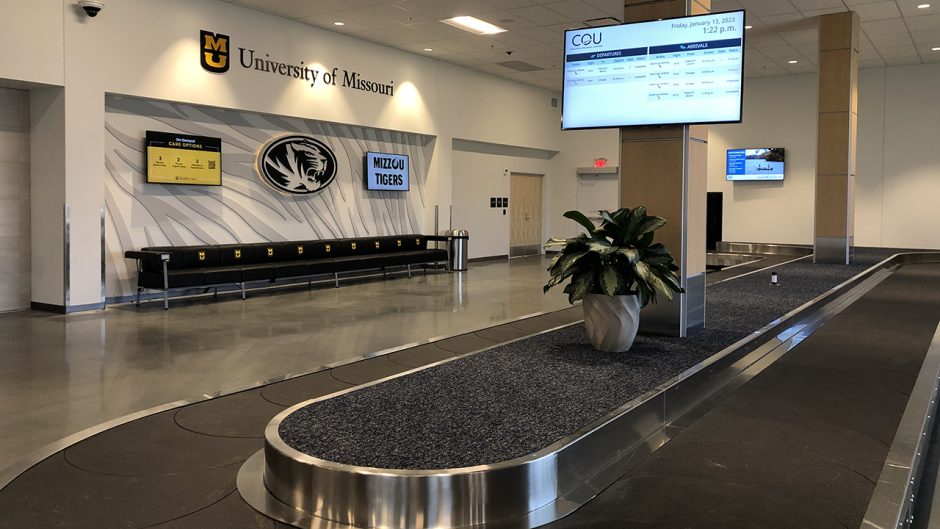an airport terminal with mizzou designs on the wall
