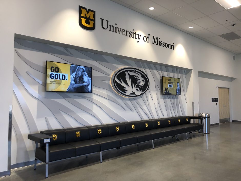 an airport terminal with mizzou designs on the wall