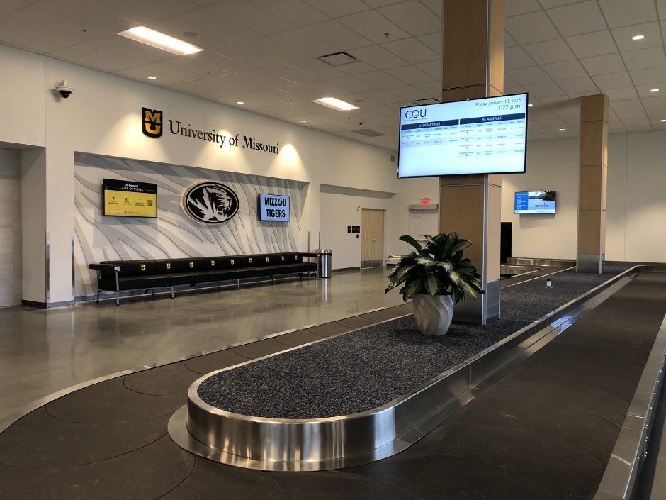 an airport terminal with mizzou designs on the wall