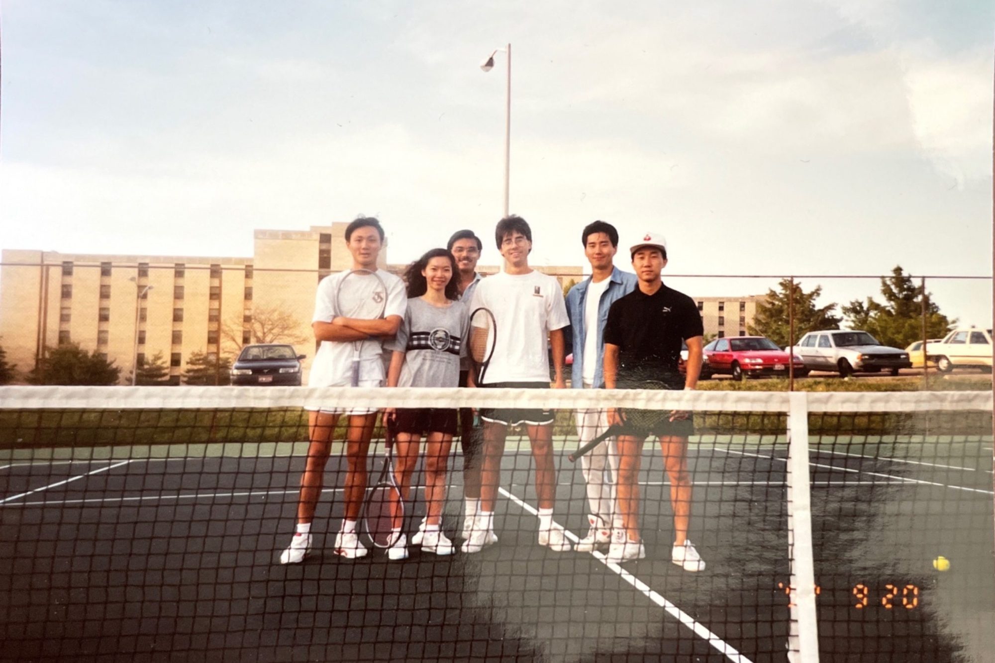 Historic photo of Chung-Ho Lin and Hsinyeh Hsieh on the tennis courts with friends