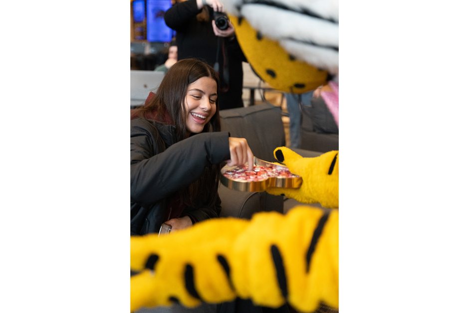 truman the tiger gives chocolates to a student