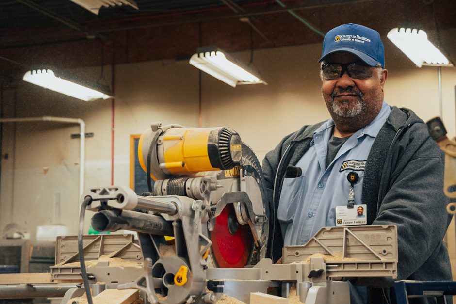 Tyrone Turner stands behind a table-saw in the shop in the General Services Building.