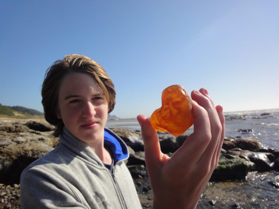 man holds up a rock