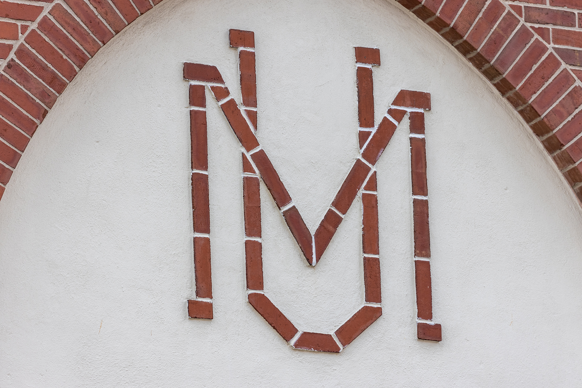close up of MU in brick and stone