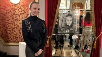 Samantha Novak stands in front of her artwork in the Missouri Theatre