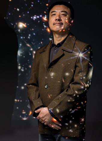 researcher in studio full of galaxies