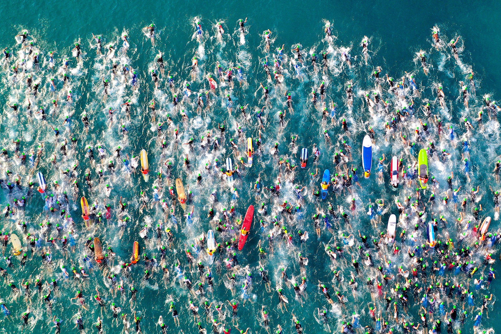 overhead photo of swimmers and surfers