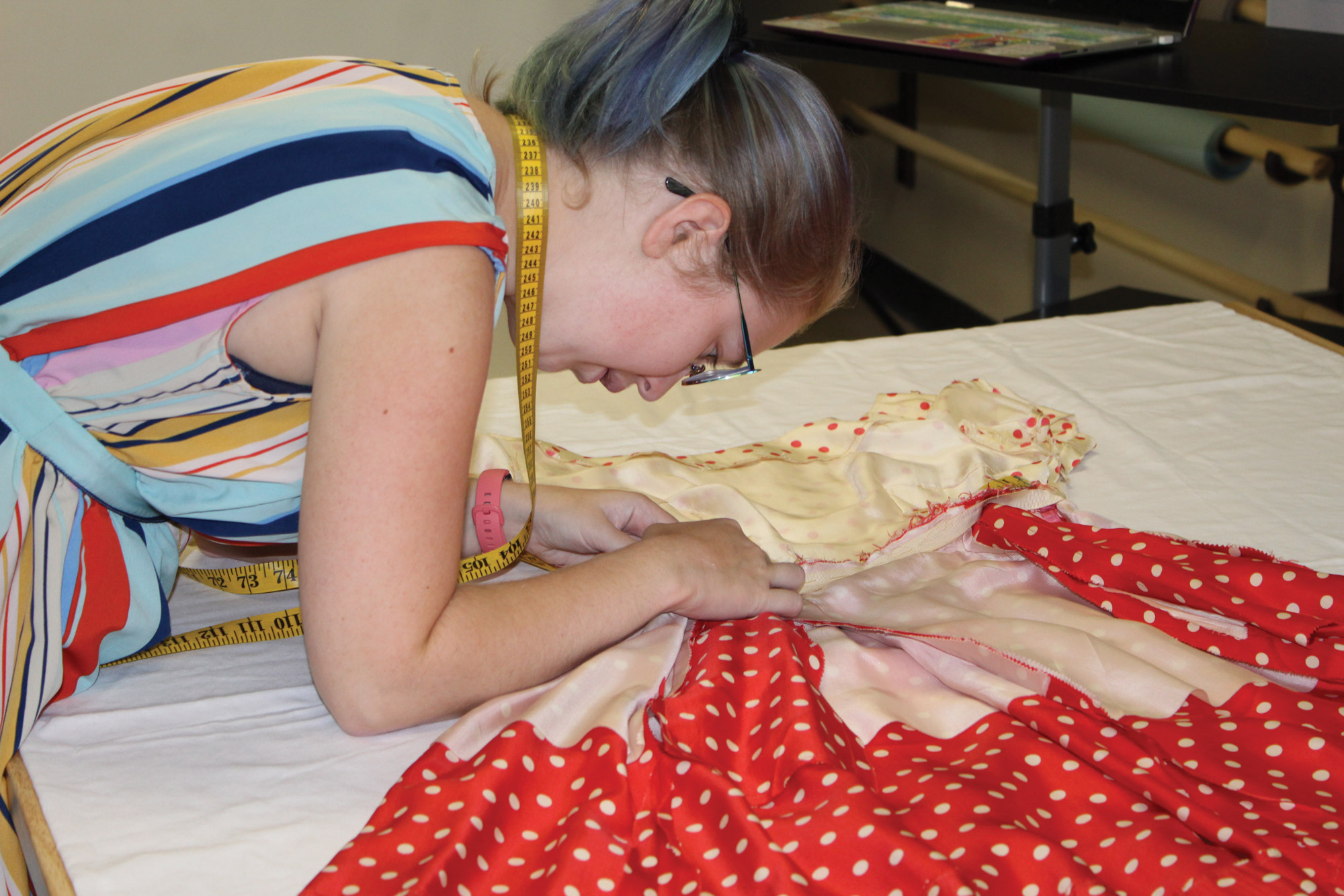 student sewing dress