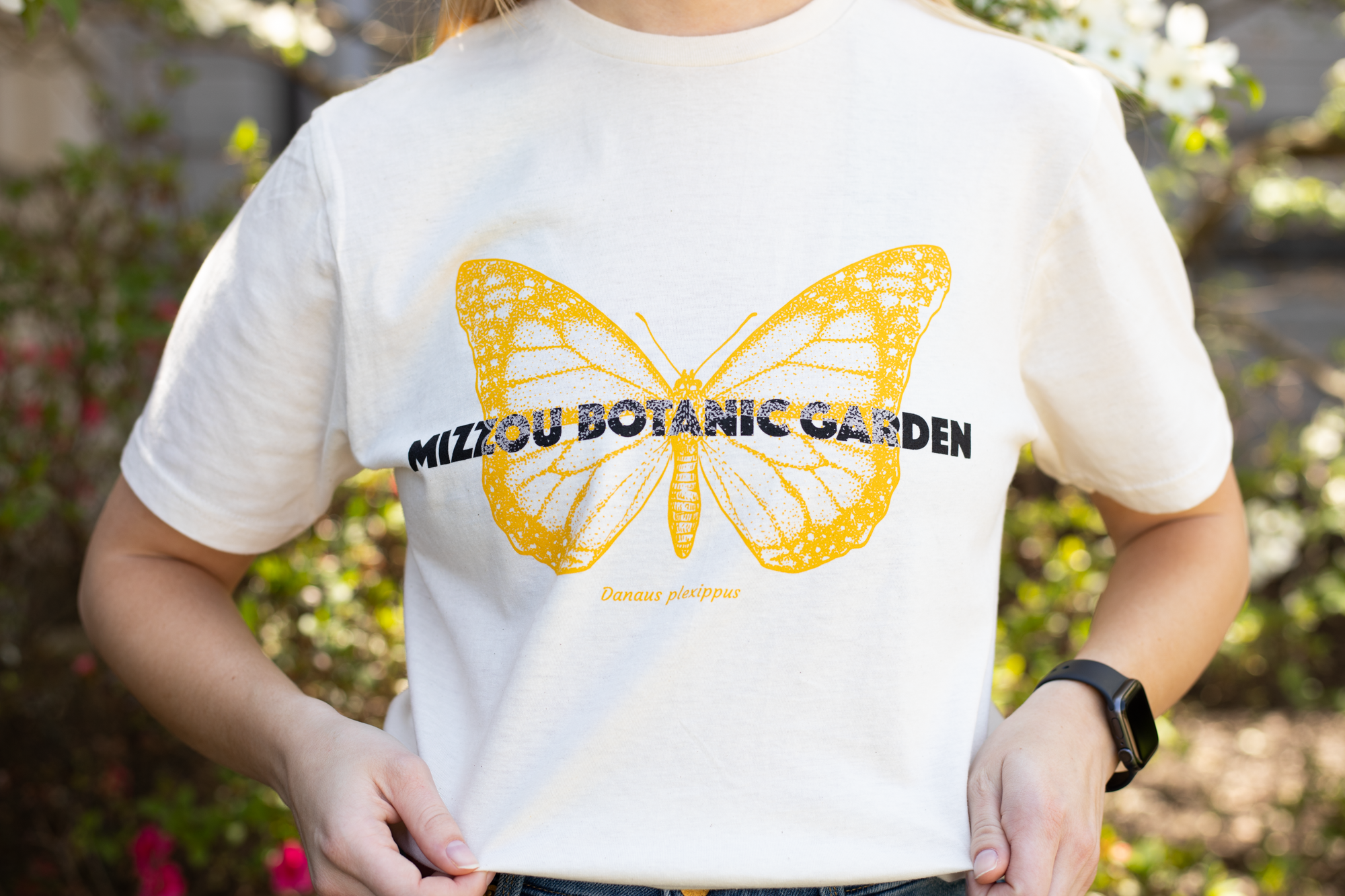 a yellow mizzou botanic garden shirt with a butterfly on it