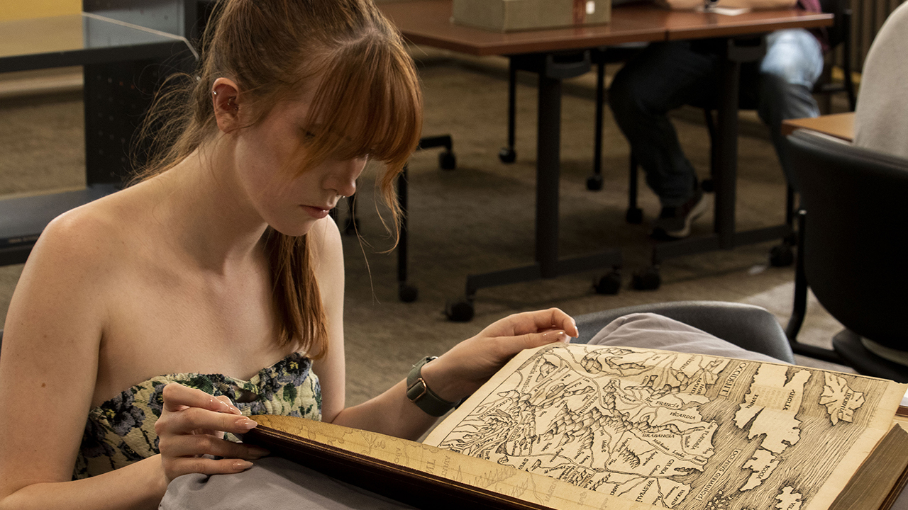 A student studies a manuscript