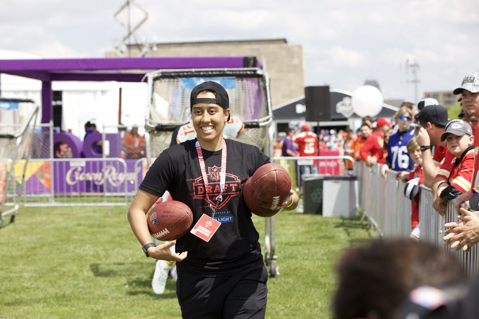 Amelia Wilson runs with a pair of footballs