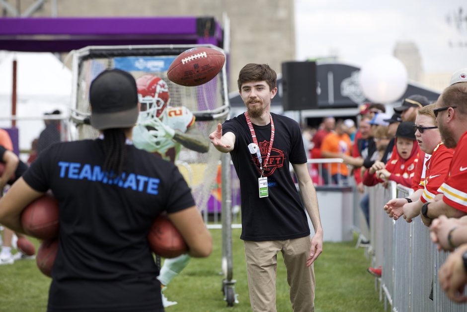 Logan Nachtrab tosses a football to his classmate