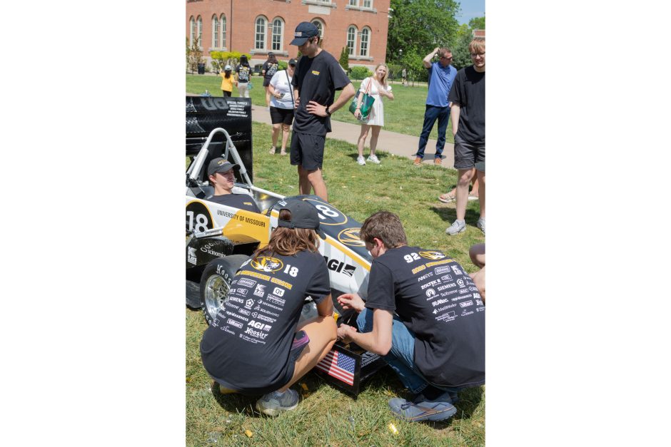 students working on a formula SAE car